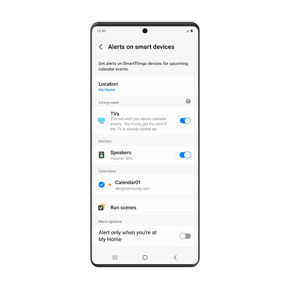 A Galaxy smartphone screen showing the 'Alerts on smart devices' settings page. On the page, it shows that upcoming calendar events can be notified on smart devices in the preset location. The "Location" is set to 'My Home.' Alerts for living room TV and kitchen speakers are enabled. 'Calendar01' is enabled in the Calendars option. Underneath is the "Run scenes" option. At the bottom, under the 'More options', the "Alert only when you're at [My Home]" setting is turned off.