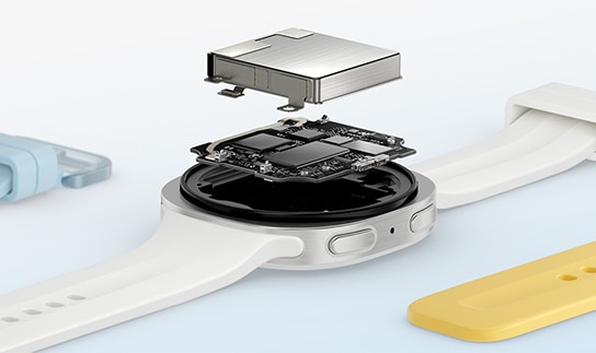 Close-up view of the components inside the case of a Samsung Galaxy Watch9 in Cream with a Cream Sport Band shown facing up with the watch battery placed on top.