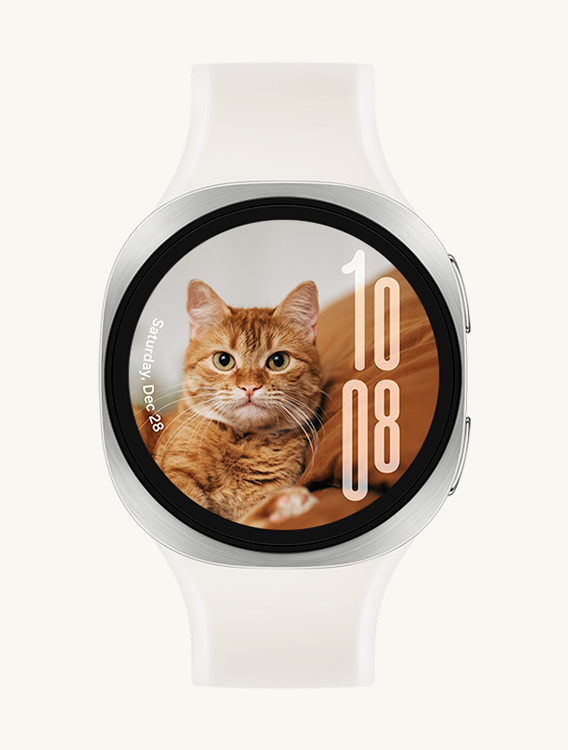 Front view and close-up angled view of Galaxy Watch9 with a Misty Band in Cream, displaying a custom Portrait Watch Face with the date on the left and time on the right, without overlapping with the cat's face.