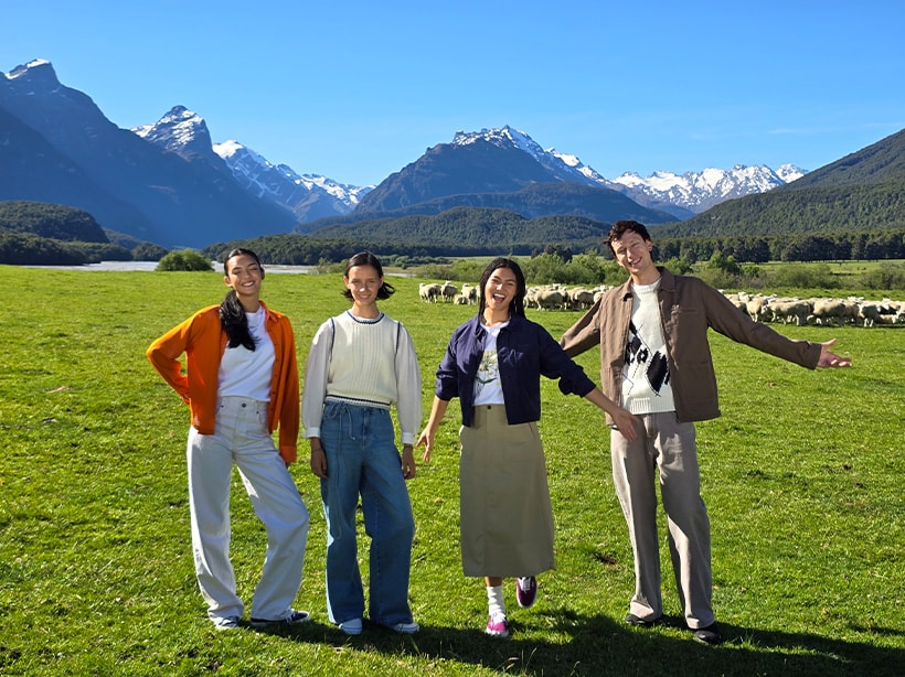 Une photo d’un champ ouvert et de montagnes avec un groupe d’amis au premier plan à un zoom de qualité optique 2x.