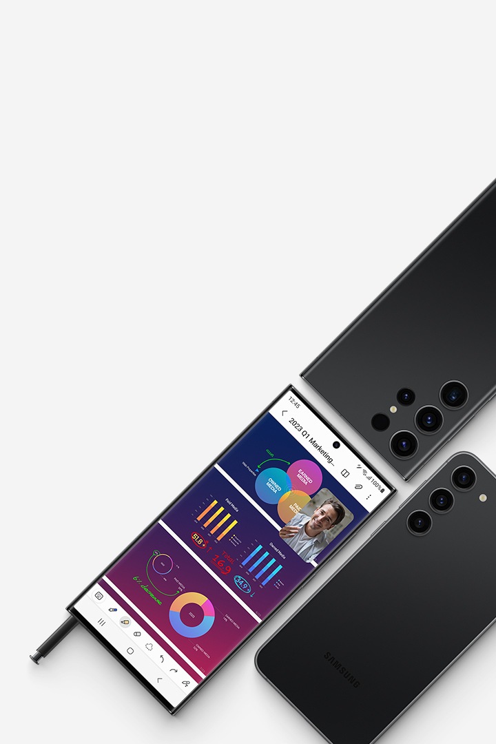 A flat lay of three smartphones: two Galaxy S23 Ultra devices and one Galaxy S23 plus. One Galaxy Ultra is seen in full from the front with an S Pen partially inserted into the bottom of the phone. The screen shows three slides of a slideshow presentation open in an app with a floating window of a video chat on top. The other Galaxy S23 Ultra and Galaxy S23 plus are Phantom Black and seen from the rear.