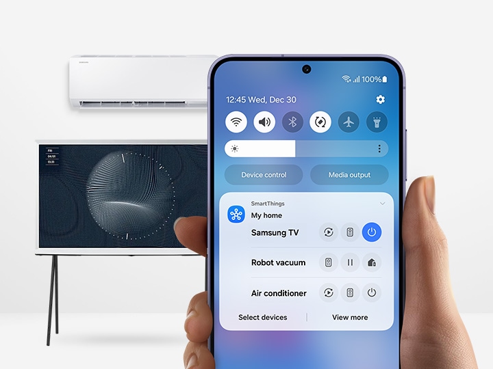 The Galaxy smartphone shows the SmartThings app quick remote UI.  TV and air conditioner are placed behind the smartphone.
