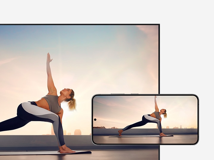 The Galaxy smartphone  and TV displaying a woman doing yoga.