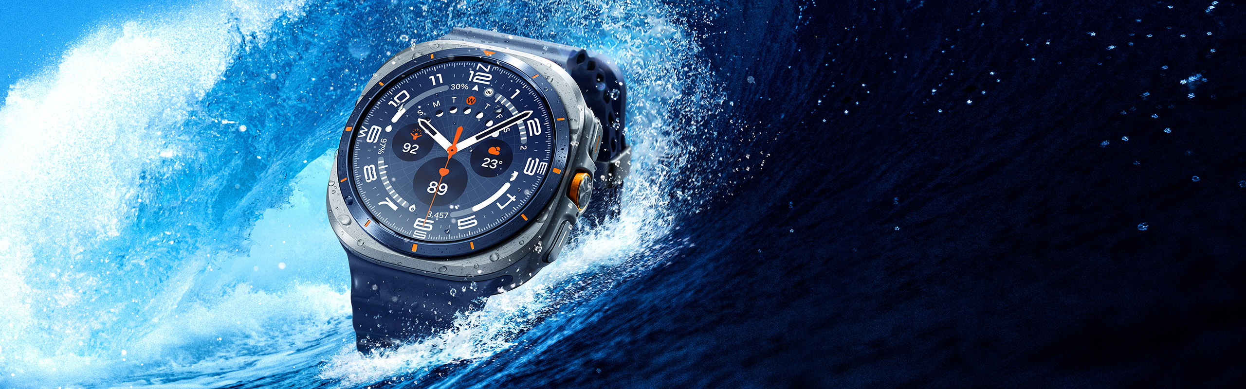 A Galaxy Watch Ultra is near a big wave, just above the surface of the ocean.