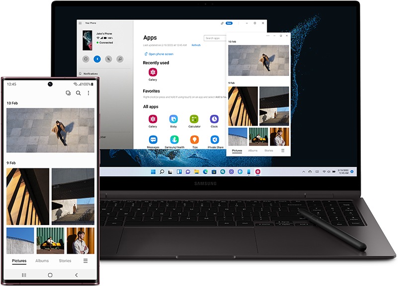 Galaxy S22 Ultra and a Galaxy Book laptop both seen from the front. Galaxy S22 Ultra has the Gallery onscreen, showing photos. Galaxy Book has the Link to Windows app onscreen, showing the same Gallery app opened on the PC.