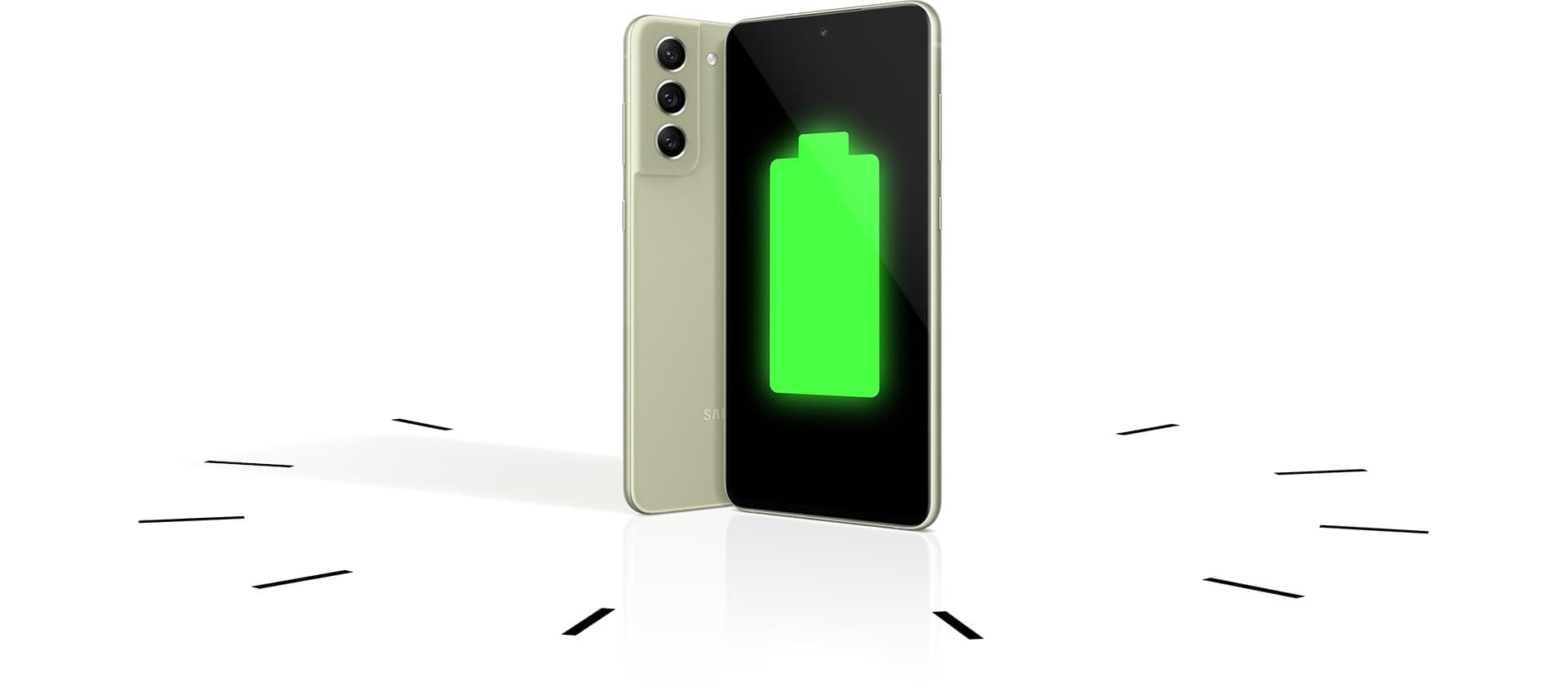 Two Galaxy S21 FE 5G phones seen standing upright, one seen from the rear and one seen from the front with a full battery icon onscreen. The phones stand within a clock to demonstrate the long-lasting battery.