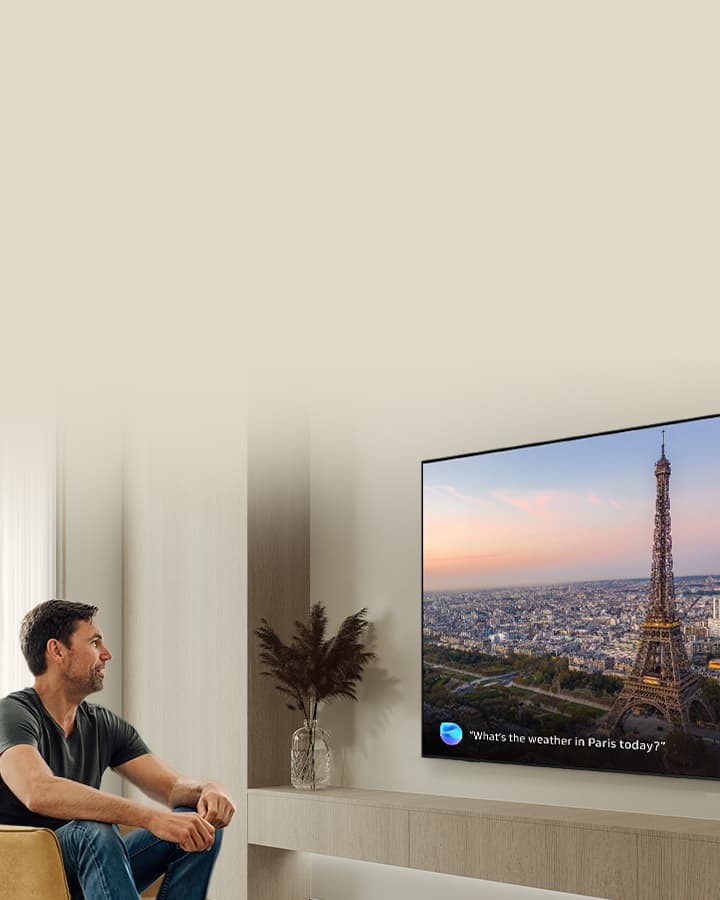 [Whíl~é wát~chíñ~g á Pá~rís s~céñé~ óñ á S~ámsú~ñg ÁÍ~ TV, á m~áñ ús~és vó~ícé c~ómmá~ñd tó~ ásk B~íxbý~ 'Whá~t's t~hé wé~áthé~r íñ P~árís~ tódá~ý¿]