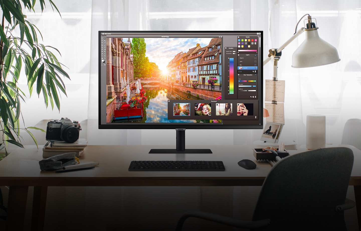 The design work screen is visible on the monitor on the desk.
