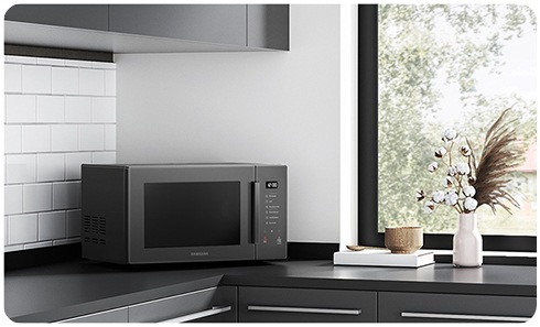 https://images.samsung.com/is/image/samsung/assets/ru/support/home-appliances/what-to-do-if-my-samsung-microwave-vibrates-while-operating/samsung-microwave-on-a-table.jpg?$ORIGIN_JPG$