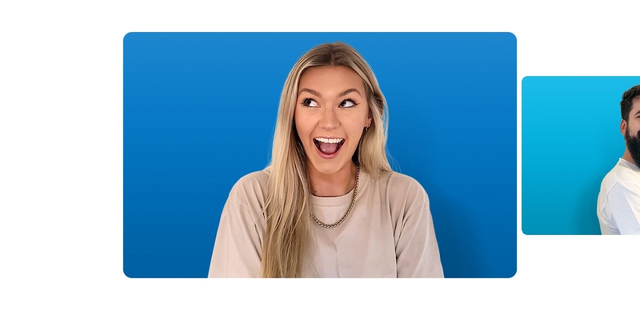 Kaitlin pictured smiling in front of a sky blue background