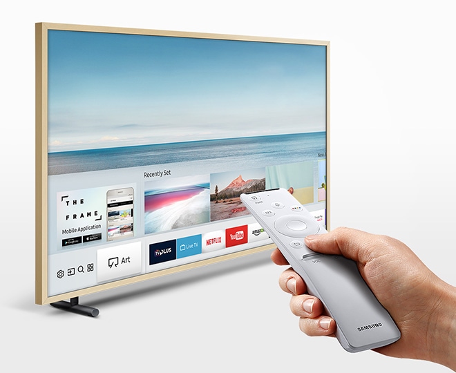 User with the One Remote Control browsing content on The Frame’s smart hub.