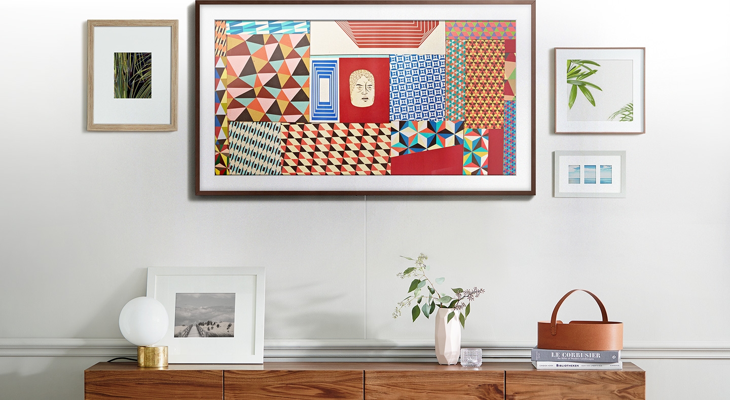 The Frame is mounted on the wall with its screen divided into two illustrating art mode on the left and TV mode on the right.
