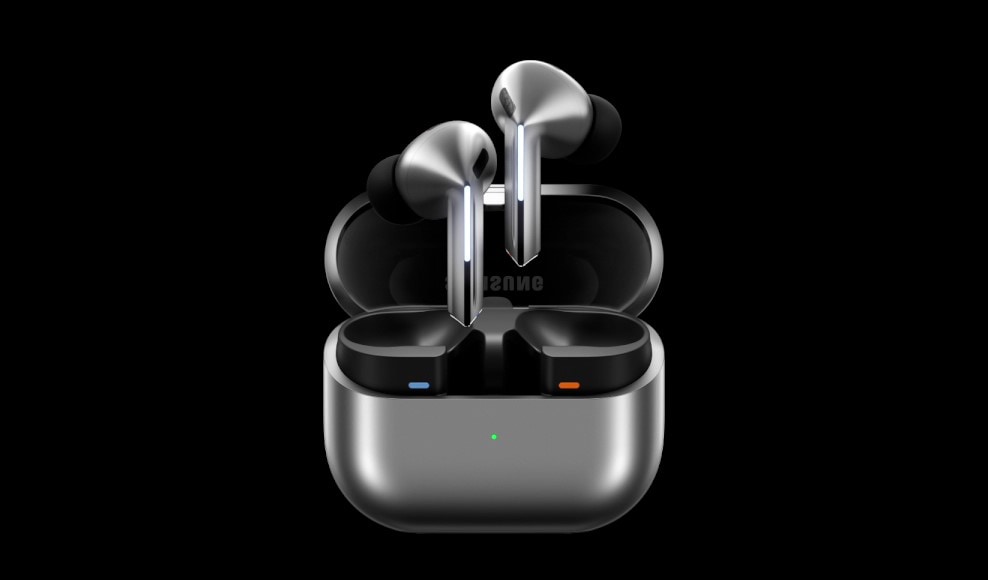 The image features a pair of Samsung Galaxy Buds3, known for their sleek design and exceptional audio quality, resting in a modern charging case. The polished silver earbuds are partially elevated from the case, which includes an indicator.