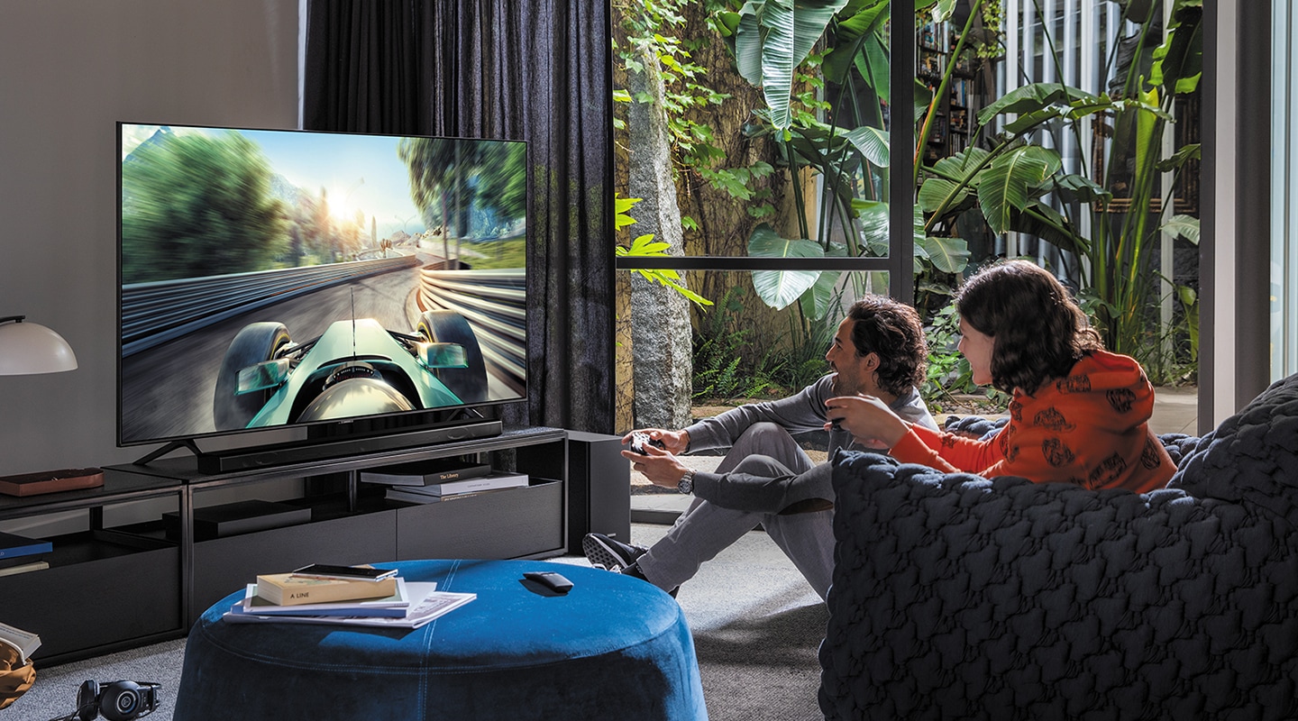 A man and women are playing a game on Samsung Smart TV.