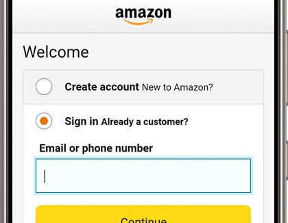 A Galaxy phone screen displaying the Amazon sign-in page with options to 'Create account' or 'Sign in', and a field for entering an email or phone number.