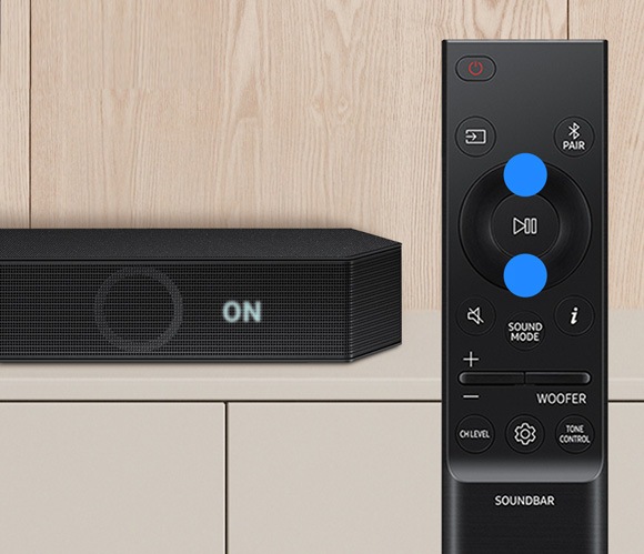 Remote control with up and down buttons highlighted, used to turn on or off Voice Enhance mode on a Samsung soundbar.