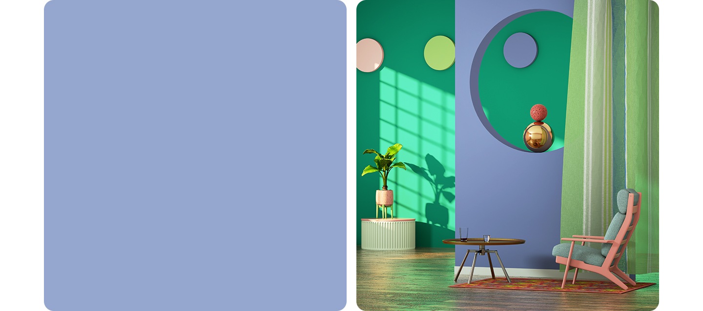 The interior of a house, filled with color. A lavender wall with a circle cut out, a green wall behind it with pink, green and lavender dots hung on it. A pink and grey chair sits in front of the lavender wall with a coffee table in front of it.