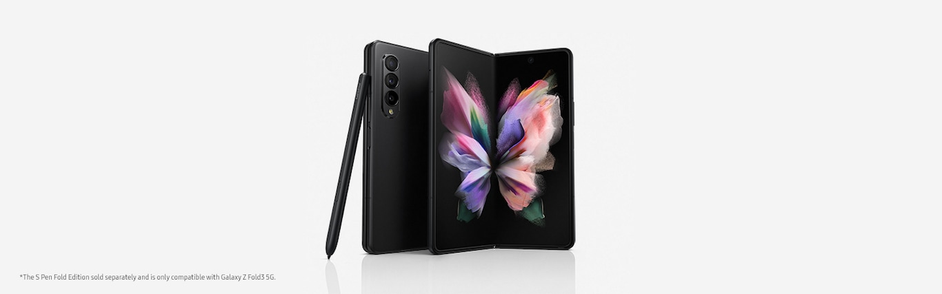 Front view of an opened Phantom Black Galaxy Fold3 is standing upright at a slight angle, behind it there is a folded Phantom Black Galaxy Fold3  showing its rear camera, and a black S Pen is standing upright leaning towards the folded Galaxy Fold3.