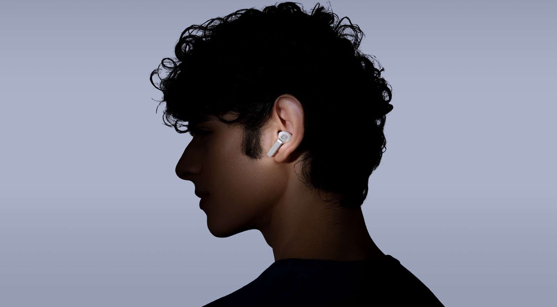 A person wearing Galaxy Buds4 Pro while looking toward the left.