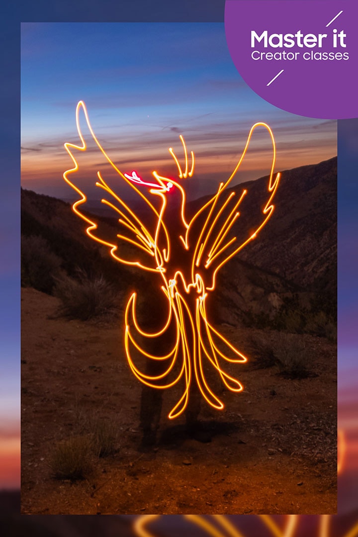 A man at sunrise makes a light painting of a rising phoenix in the air. Master it. Creator classes.