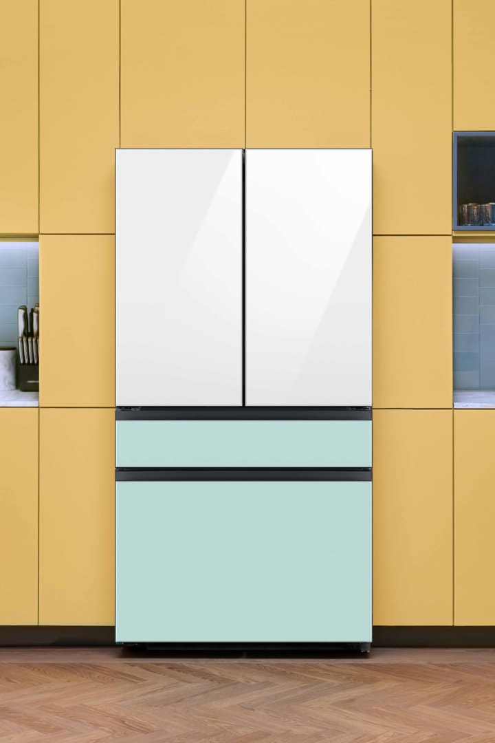 Samsung Bespoke 4-Door French Door Refrigerator in White Glass and Morning Blue Glass in a kitchen with orange cabinets