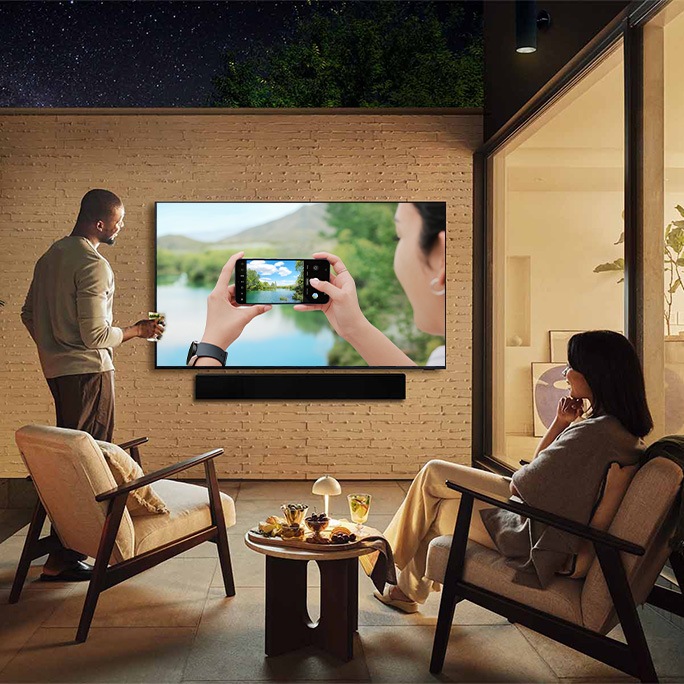A compelling image showcasing diverse individuals interacting with Samsung technology.