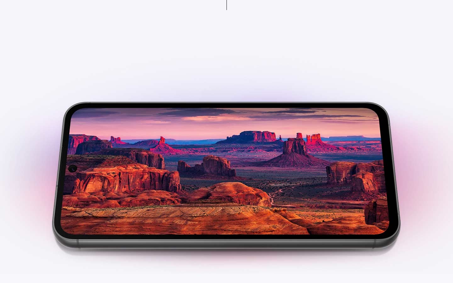 A Galaxy S23 FE device displaying at full screen red and purple mountain landscape captured by …