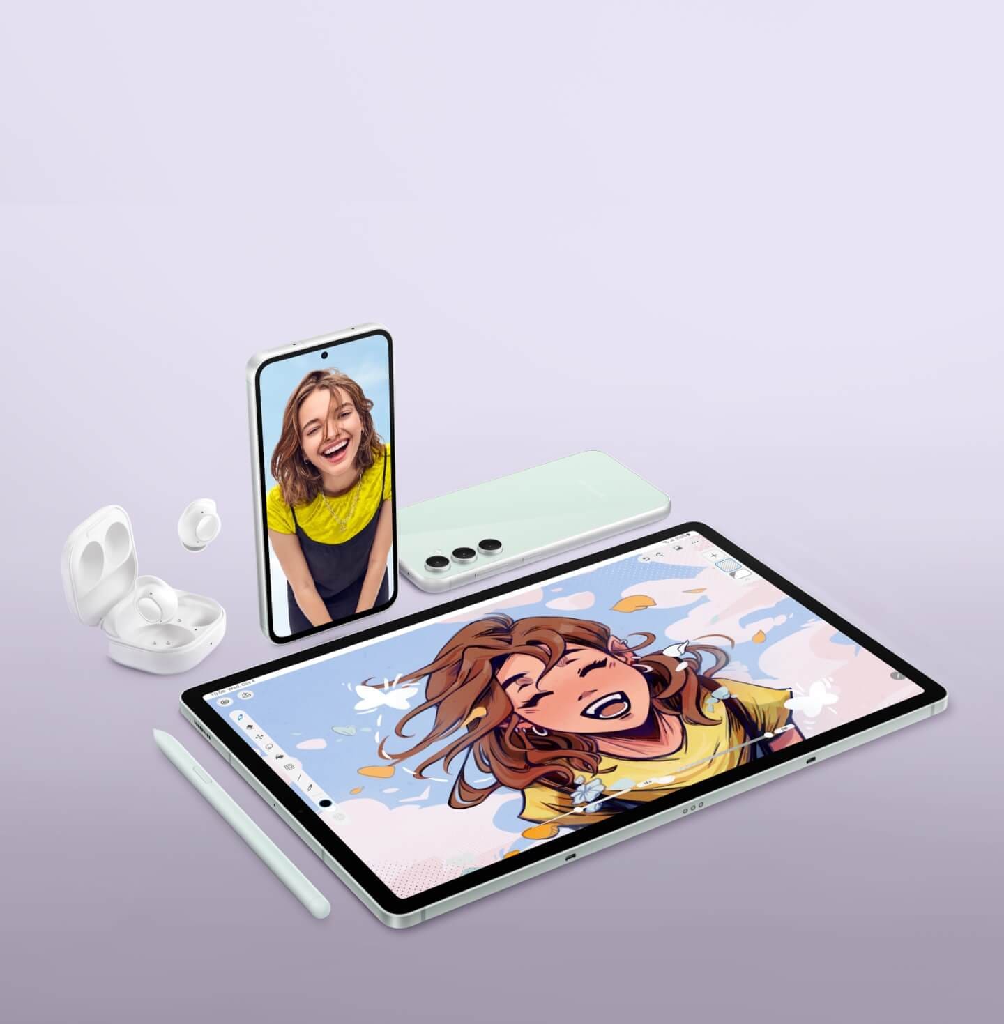 An open case of Galaxy Buds FE is seen with one earbud inside and one earbud outside. A Galaxy S23 FE device stands upright with a smiling woman on its screen. Another Galaxy S23 FE device lies face down showing its rear. A Galaxy Tab S9 FE Plus tablet shows a digital drawing of the smiling woman, with an S Pen placed nearby.