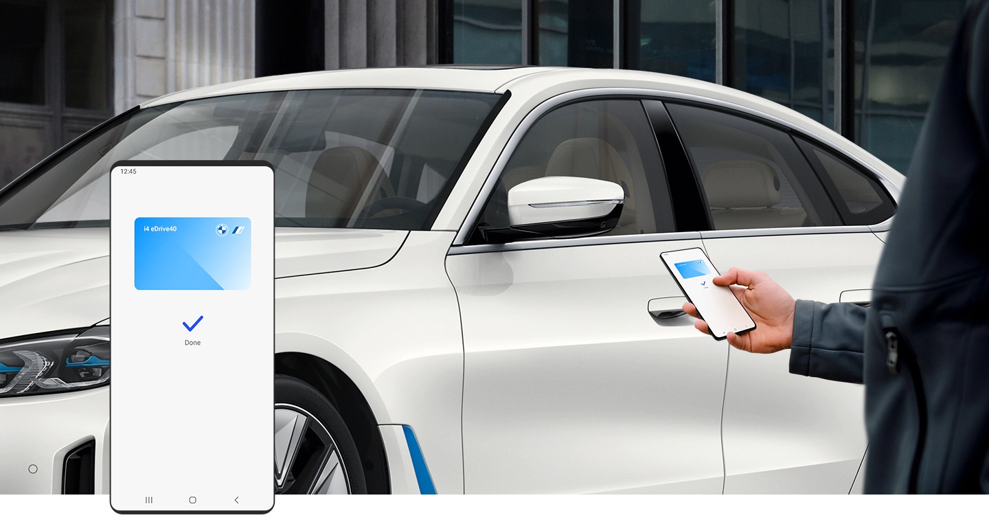 A man holds up his Galaxy smartphone to his car door. A screenshot of the smartphone shows that the Digital key feature of Samsung Pass is opening the BMW series 1 vehicle.