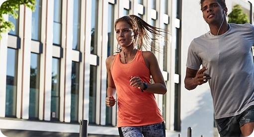 A woman and a man running outside