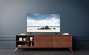 A woman is watching TV. SAMSUNG 55" Crystal 4K Smart UHD TV UA55TU8000