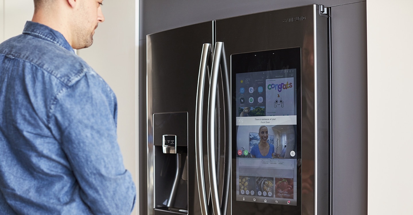 A man using applications on fridge