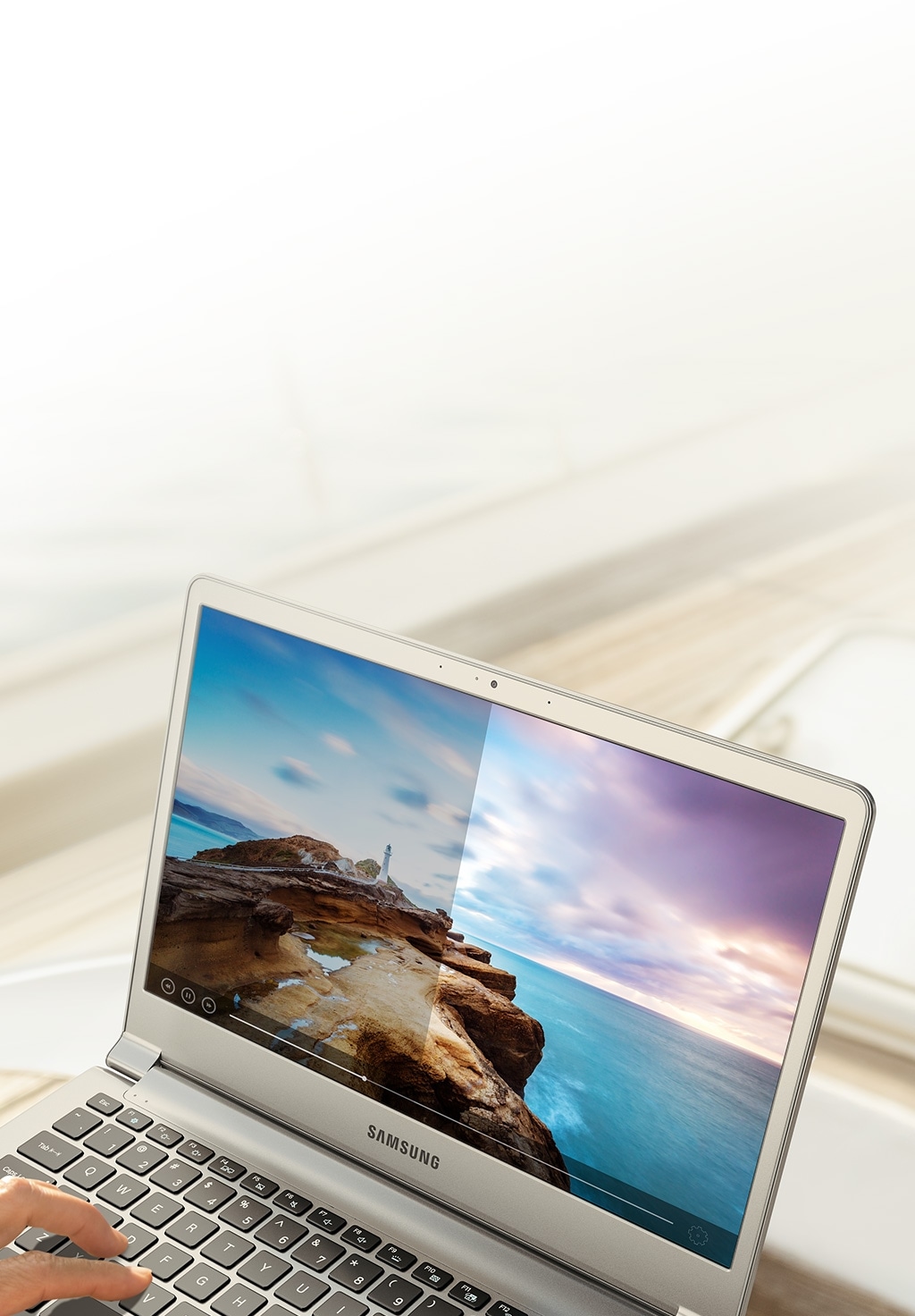 An image showing a user viewing a photo of a pier on the Samsung Notebook 9's display.