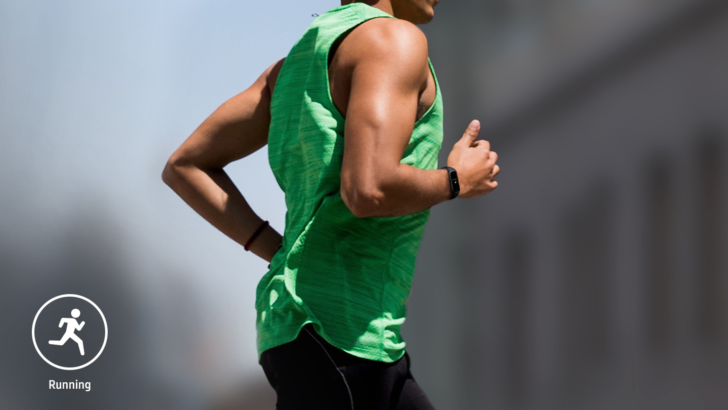 You can see a close up of the back of a man wearing a black Galaxy Fit2 on his right wrist.