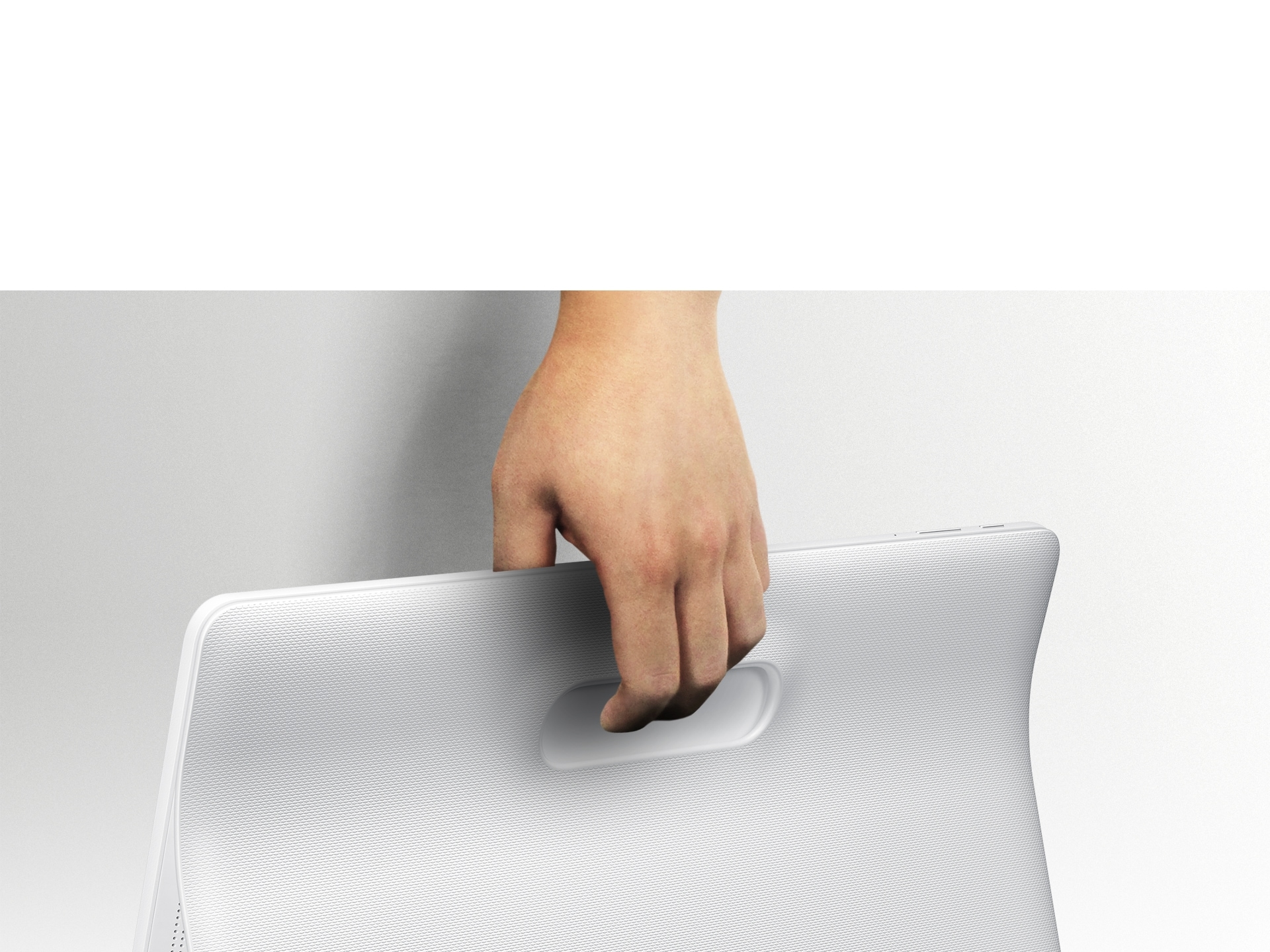 An image showing a user carrying a Galaxy View device using its rear handle.