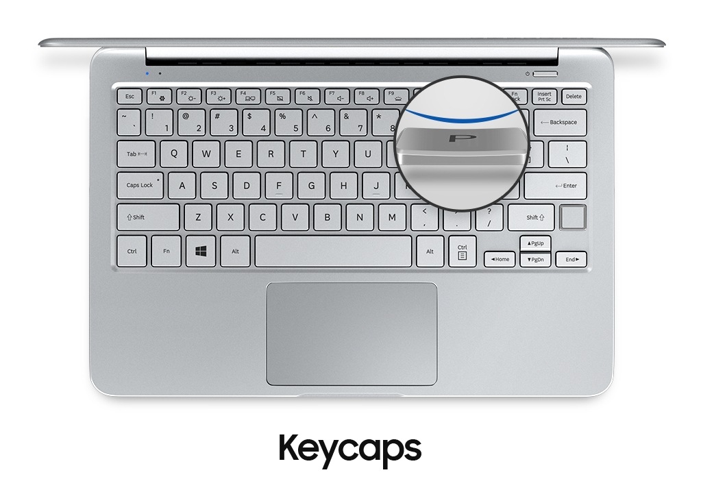 An image showing a top view of a silver Notebook 9 device’s cover open,with  its keyboard and a magnified image of one of its keycaps.