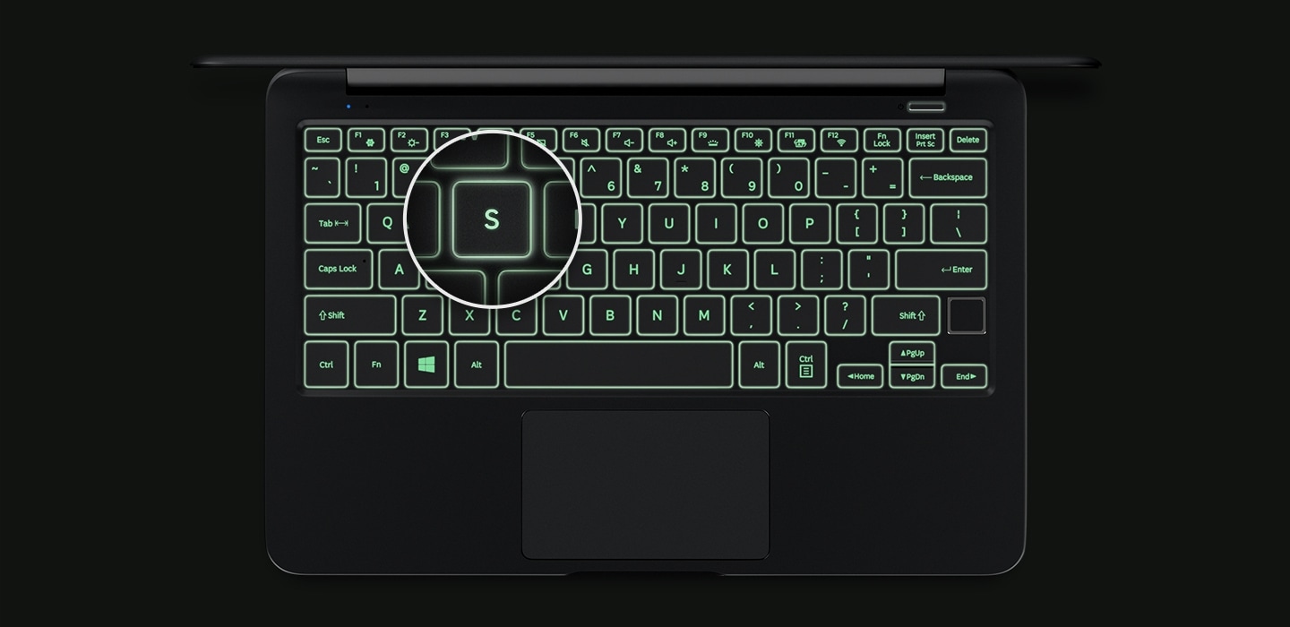 An image showing a top view of the Notebook 9’s cover open, with a backlit keyboard and a magnified image of its “S” key.