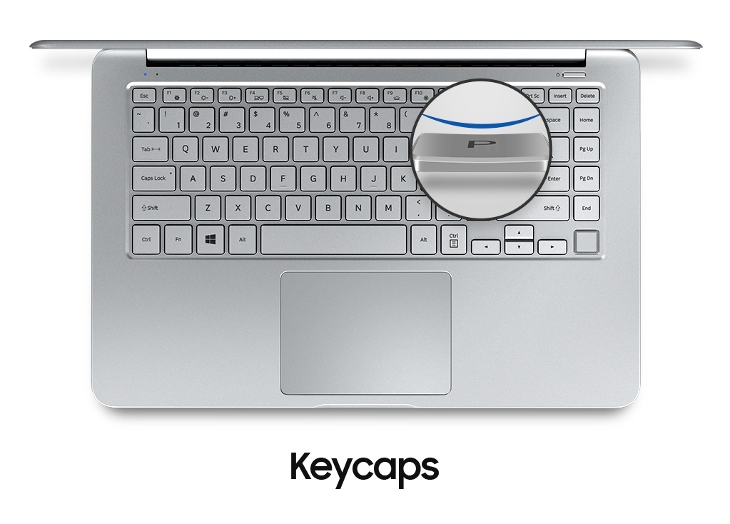 An image showing a top view of a silver Notebook 9 device’s cover open,with  its keyboard and a magnified image of one of its keycaps.