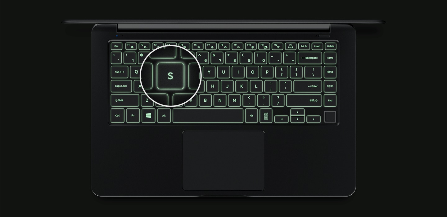 An image showing a top view of the Notebook 9’s cover open, with a backlit keyboard and a magnified image of its “S” key.