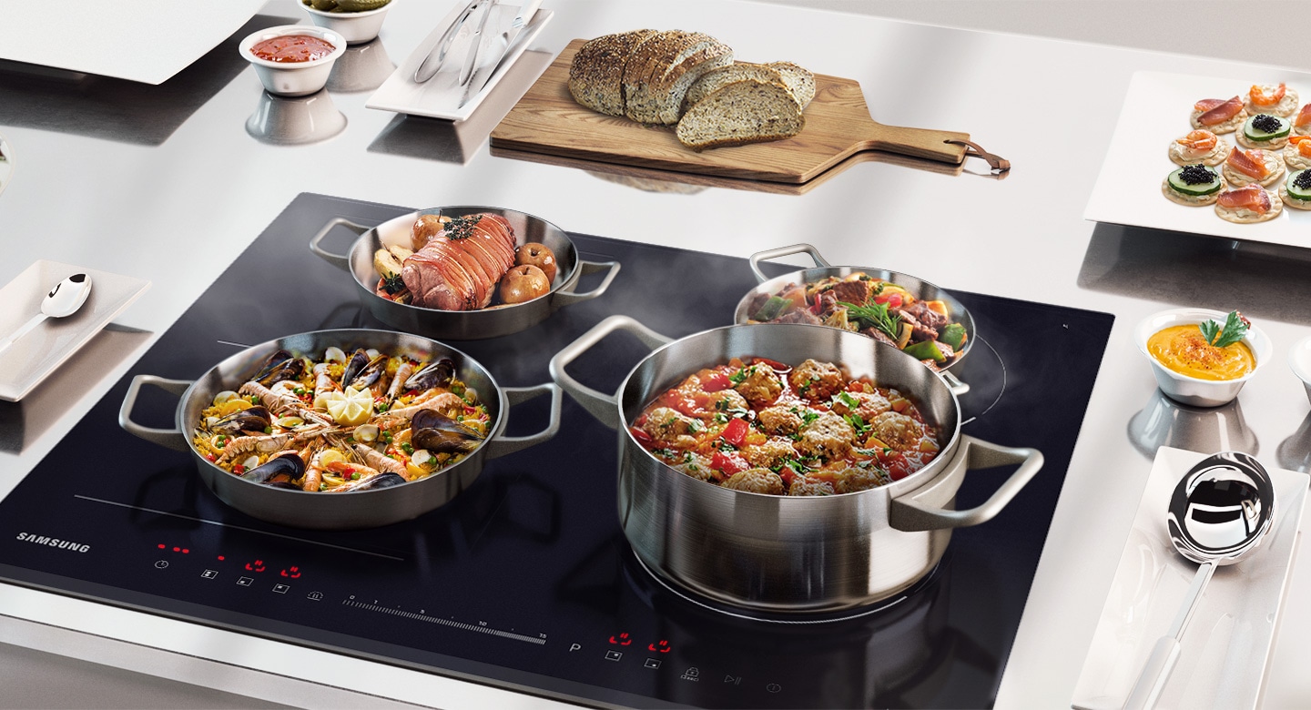 On the Samsung induction hob there are pans with ready-to-serve foods that are kept warm before being brought to the table.