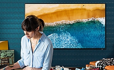 a woman facing front, TV back