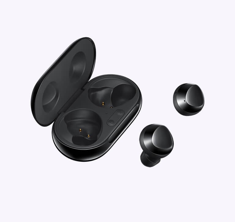 A pair of black earbuds sit parallel to an open charging case.