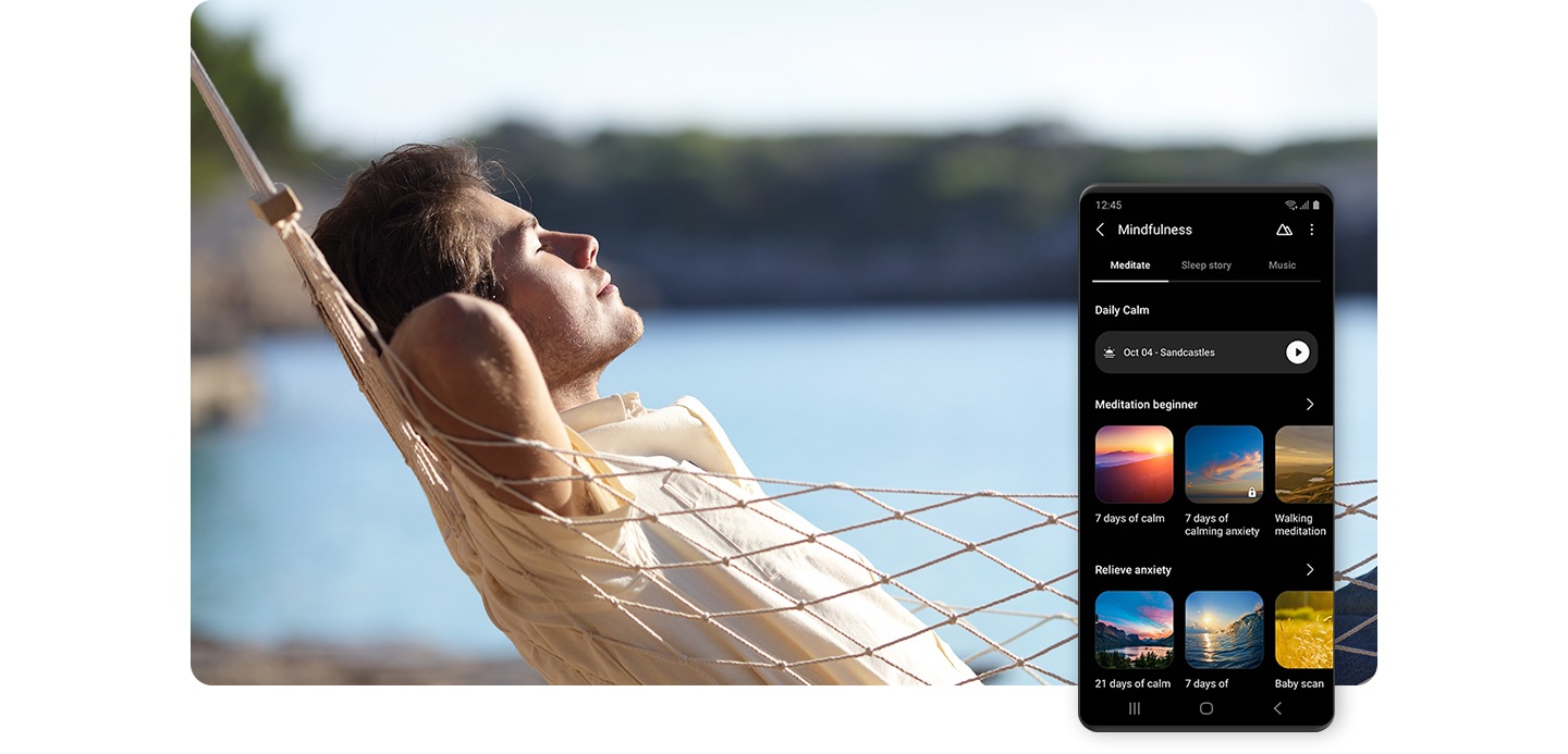 Galaxy smartphone shown displaying various Mindfulness meditation exercise videos. Behind the smartphone, a man is shown relaxing in a hammock by a lake.
