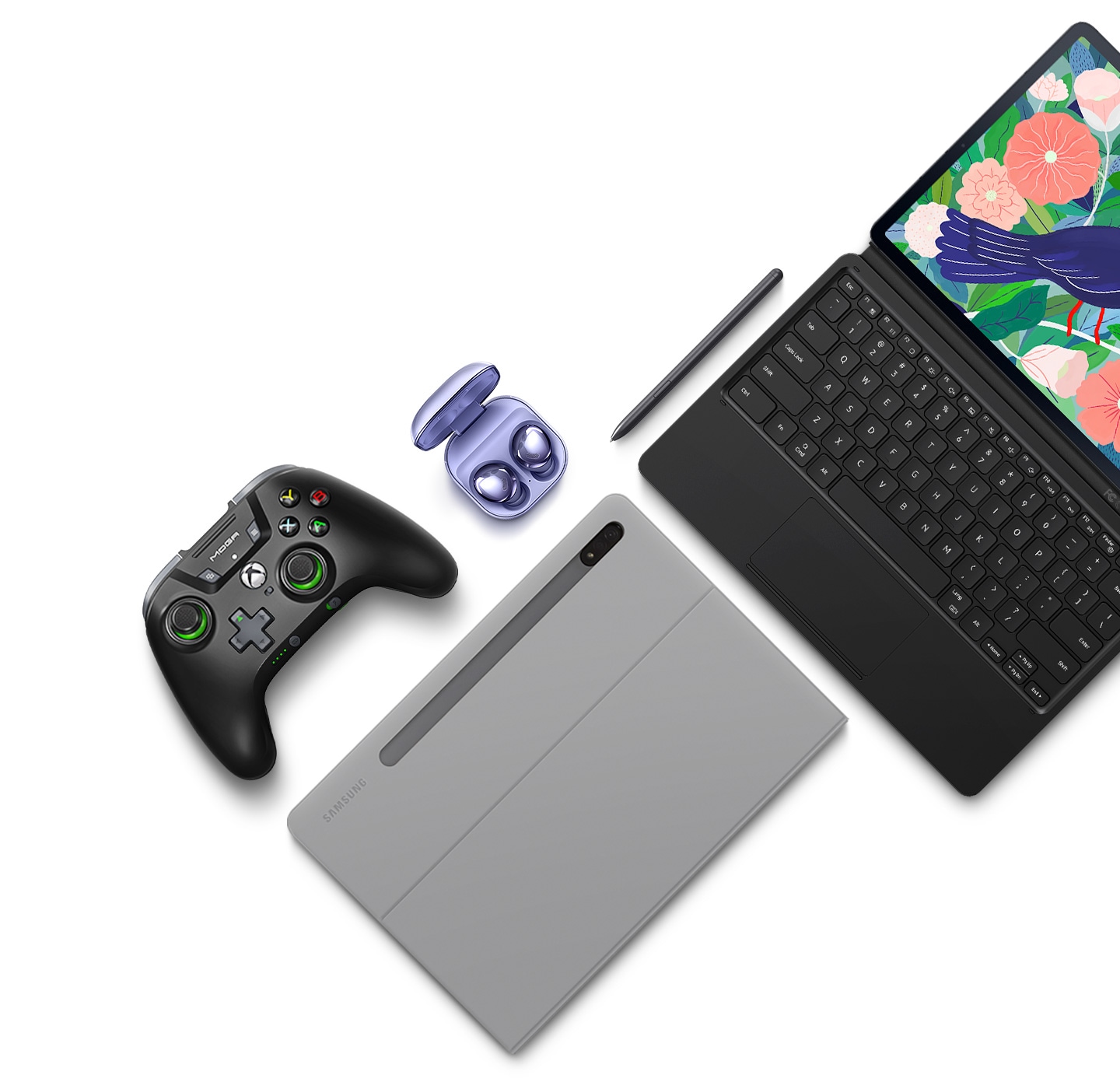 Flat lay of Galaxy Tab S7+ and its accessories. A Galaxy Tab S7+ attached to the BookCover Keyboard, a Galaxy Tab S7+ inside the BookCover, S Pen, game controller, and Galaxy Buds Pro