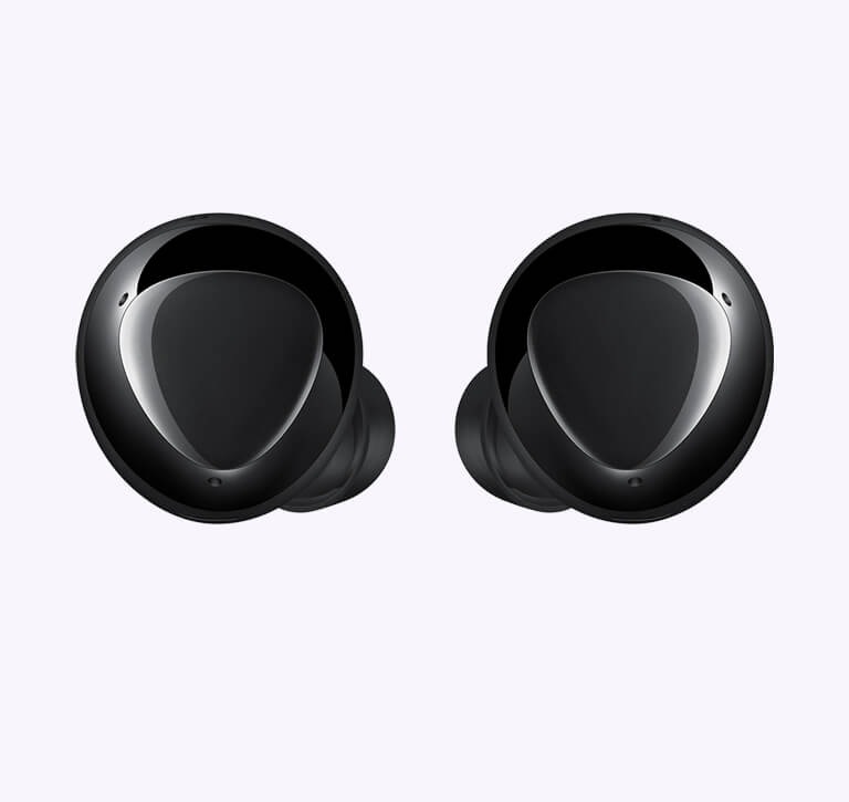 An enlarged pair of black earbuds displaying the triangular design on the outer surface.