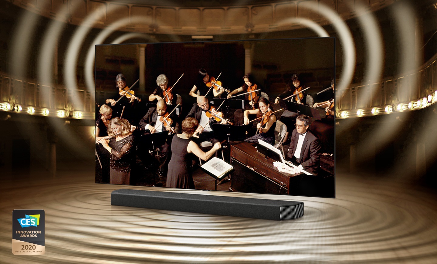 QLED TV and Soundbar in a theater with an orchestra playing onscreen. When Q-Symphony is on sound emits from TV and Soundbar. 2020 best of innovation, CES innovation awards logo is under the TV.