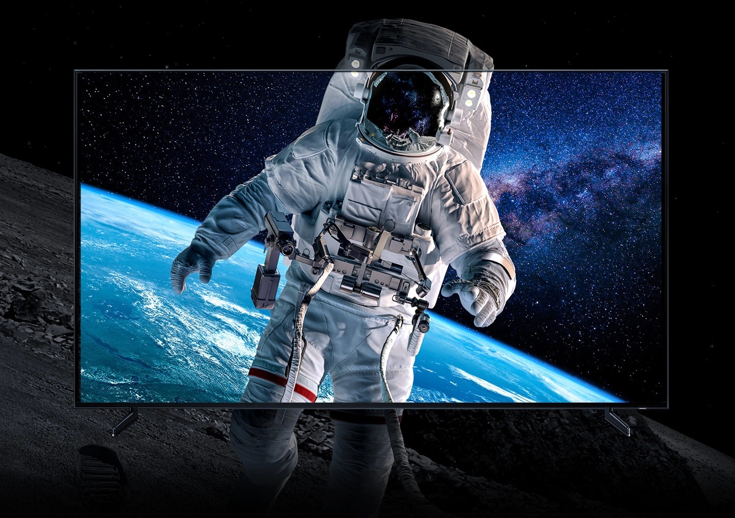 Closeup shot of an astronaut in space, displayed in full color within a QLED 8K screen, as the image bleeds out outside of the screen to demonstrate how realistic the images appear with 8K definition. 