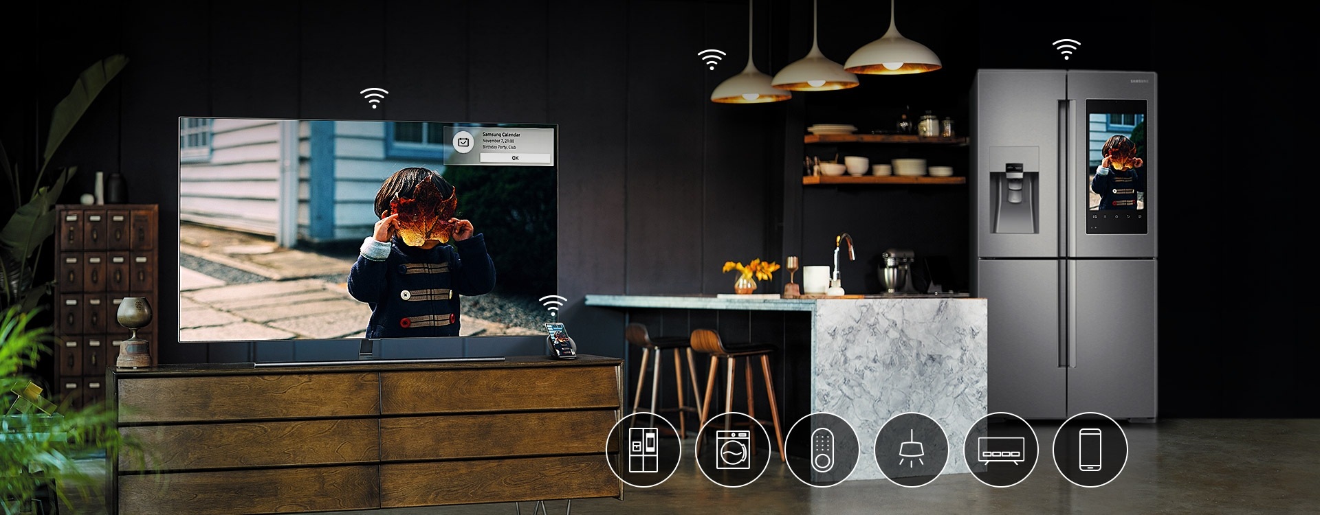 The Samsung QLED TV in the living room, mobile phone, and the refrigerator standing next to the kitchen table are connected with wi-fi to function together harmoniously. 6 icons are overlaid on image, representing possible connecting devices such as TV, door lock, refrigerator, washing machine, lightings and mobile phone.