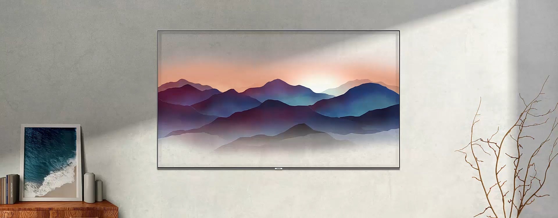 A video shows the various options for Ambient Mode. In Deco Mode, an image of mountains in the QLED TV on the wall is moving naturally. The room goes dark as the time changes from day to night. In Info Mode, the QLED TV shows the current location and temperature. The screen goes dark as the time changes from day to night. In Photo Mode, photo list appears on the Samsung QLED TV. The screen focuses in on the selected picture. In Music Mode, A notification for playing music appears on the QLED TV on the wall