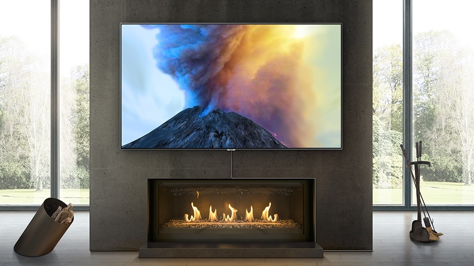 QLED TV neatly hanging above fireplace with Invisible connection